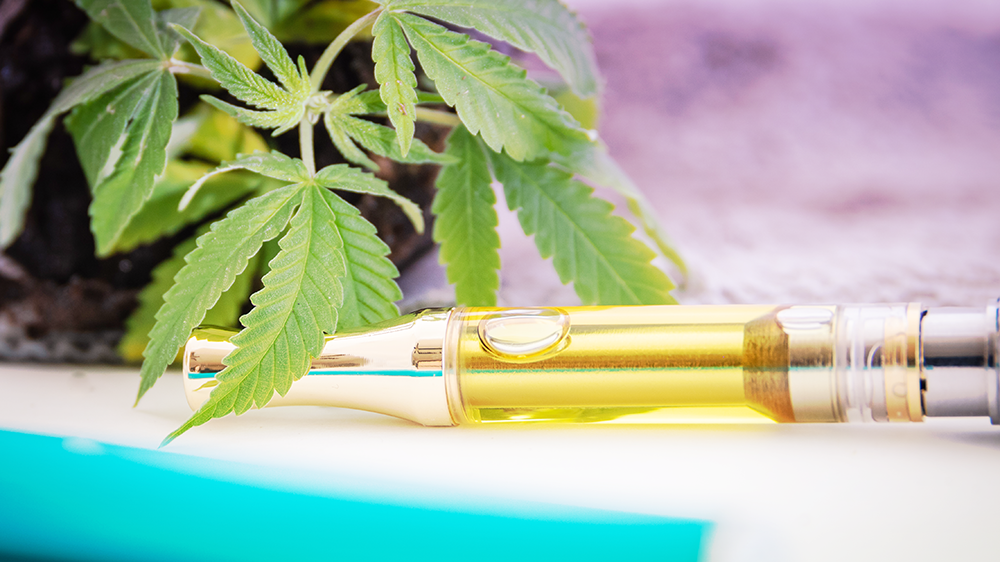 image of a vape cart laying on it's side with a cannabis leaf
